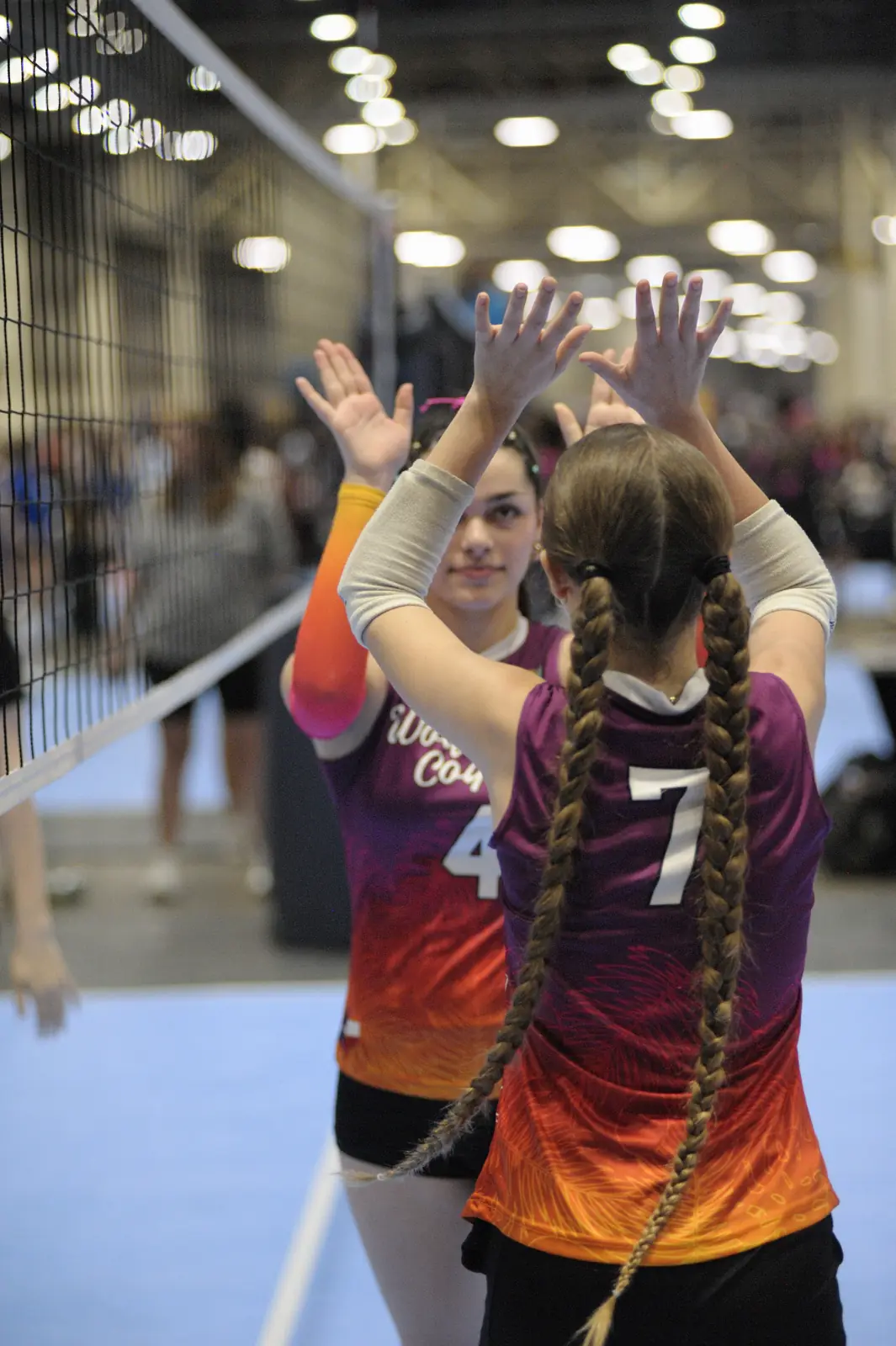 Two Wolfpack Coquí players high-five between points at a tournament